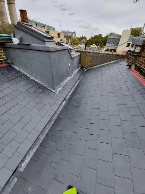 Newly completed slate roof with lead flashing at the valley