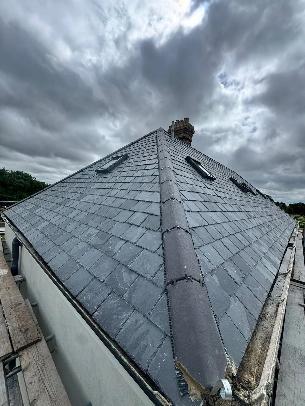 High-spec natural slate hipped roof with dry ridge capping and rooflights