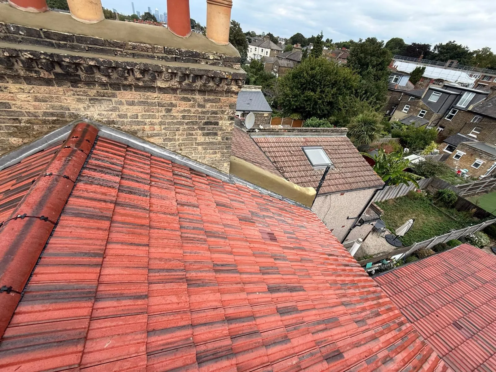 Red interlocking tile roof with new lead flashings around the chimney and valleys
