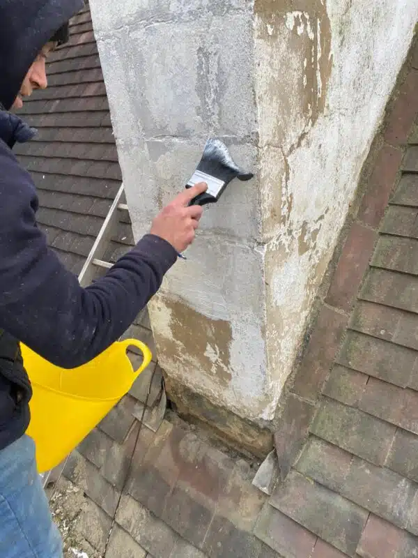 Chimney repair and pointing work on a tiled roof