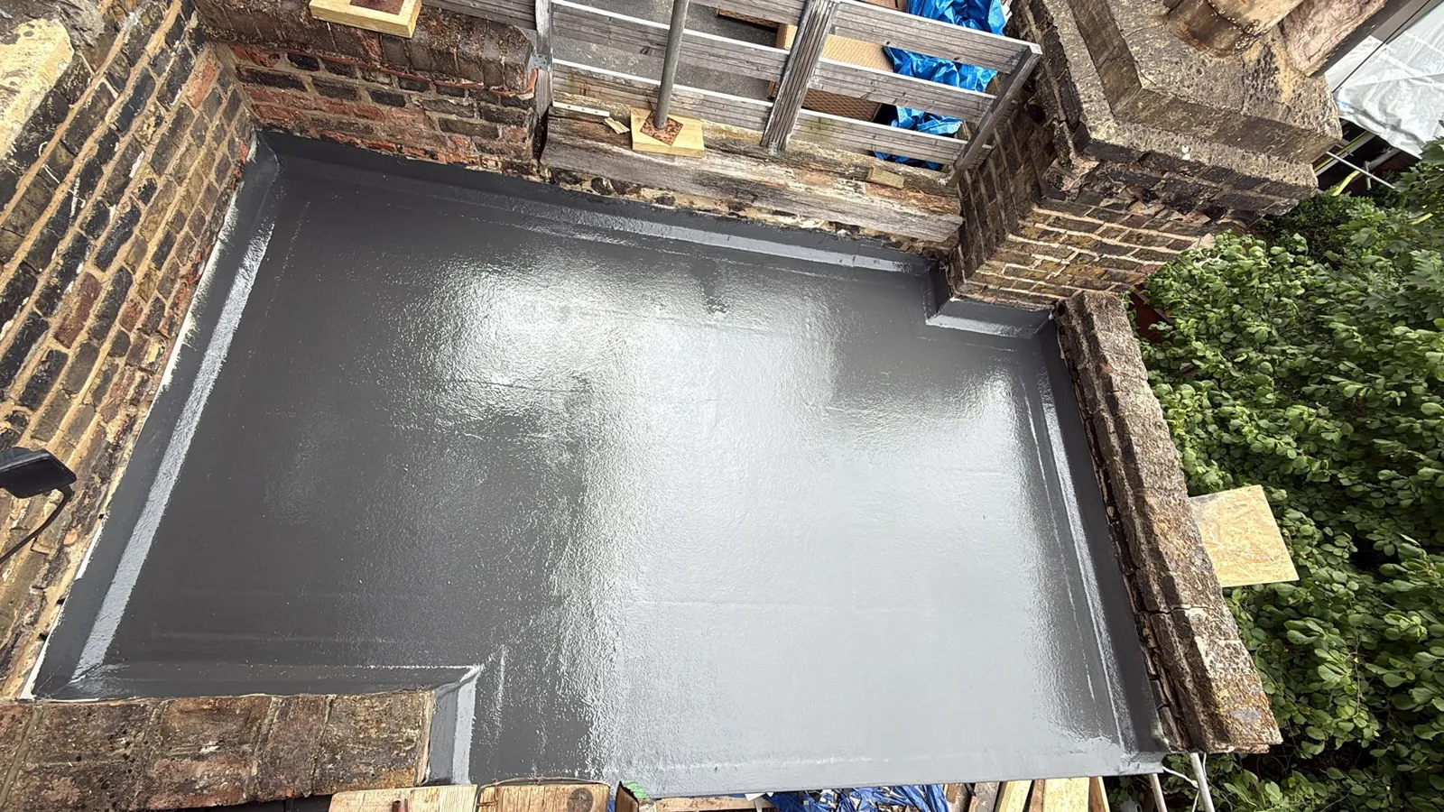 Finished seamless dark grey GRP fibreglass flat roof with a smooth topcoat