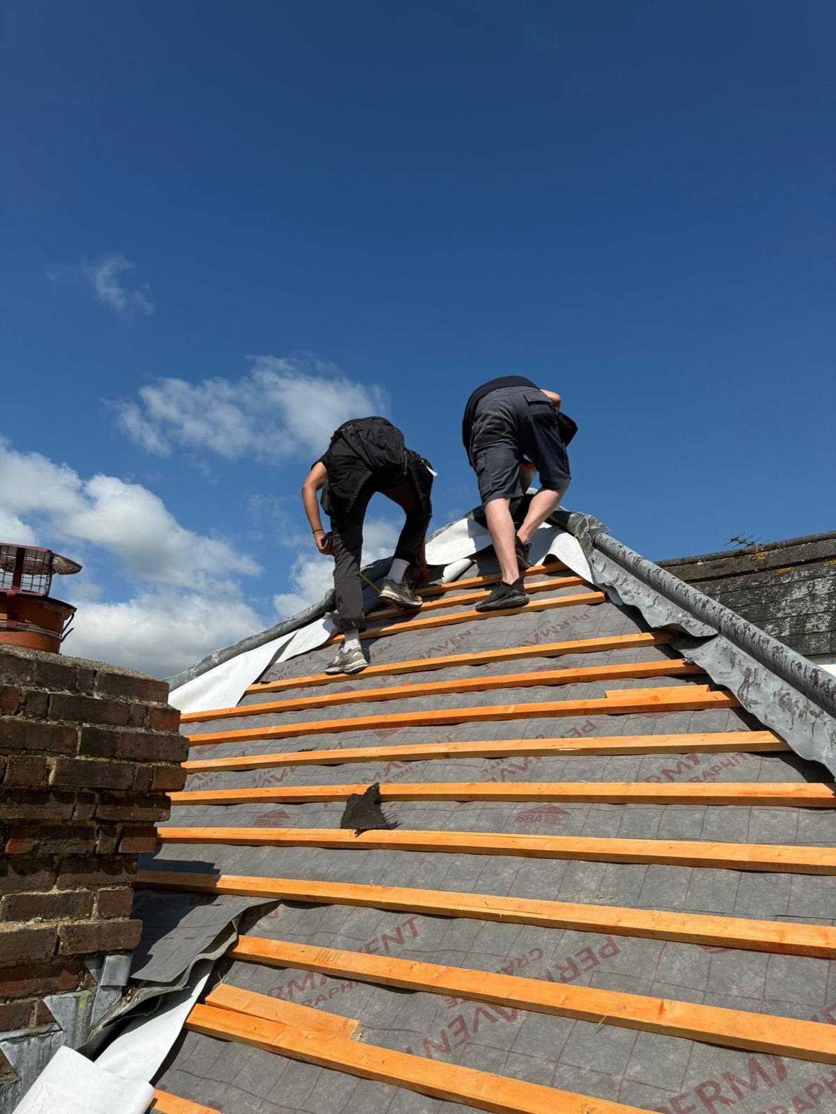 Timber battens and breathable membrane being installed on a stripped pitched roof