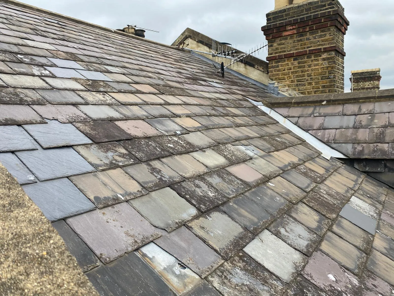 Slate repairs secured with lead tingles on a Victorian roof