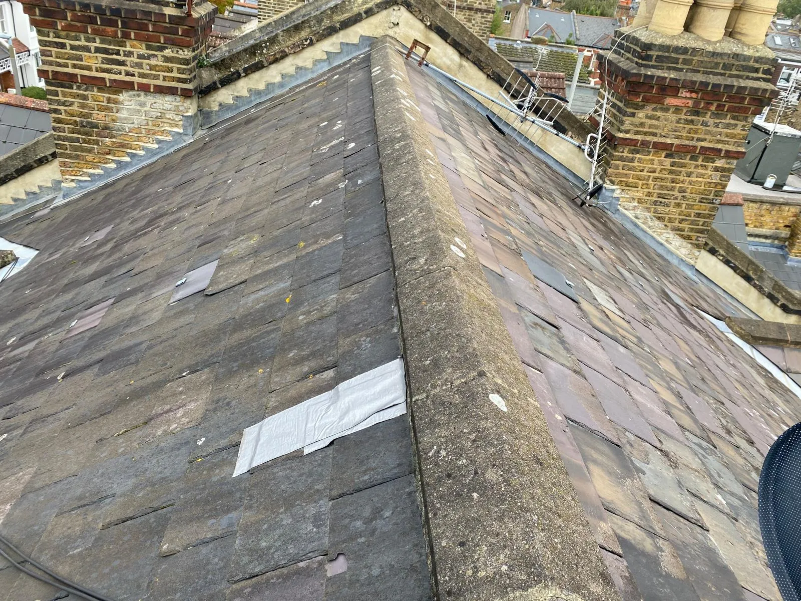 Victorian slate roof under inspection, showing slate courses and period detailing